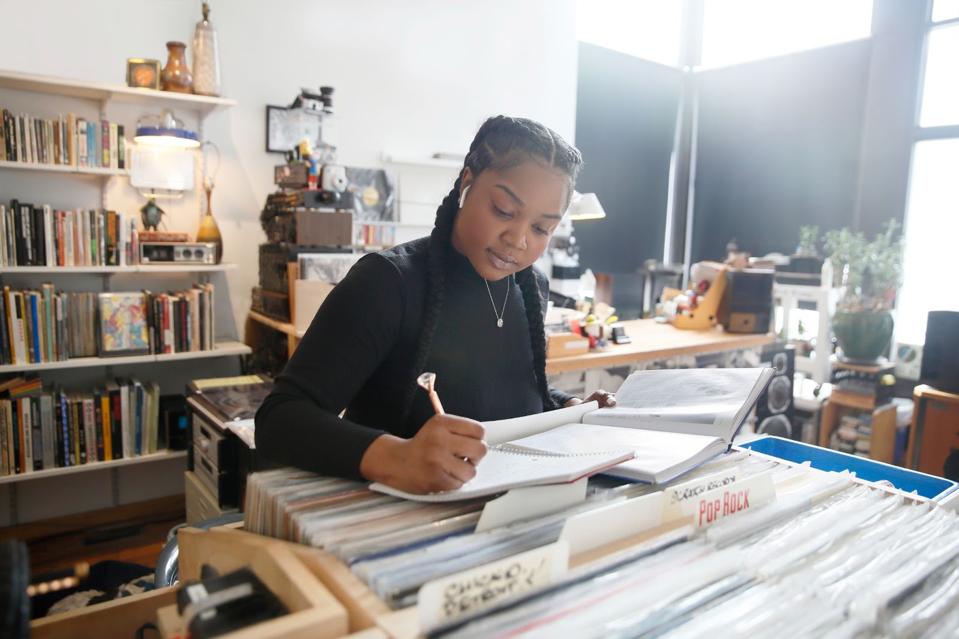 Student studying at a record shop