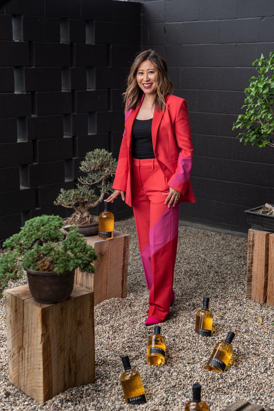 A whiskey owner surrounded by bottles.