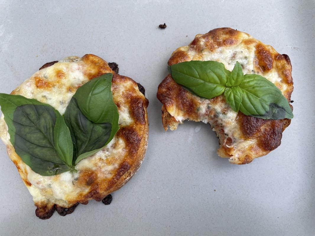 Photo by Elizabeth Karmel of an English Muffin Margarita Pizza with a Bite Taken Out of It