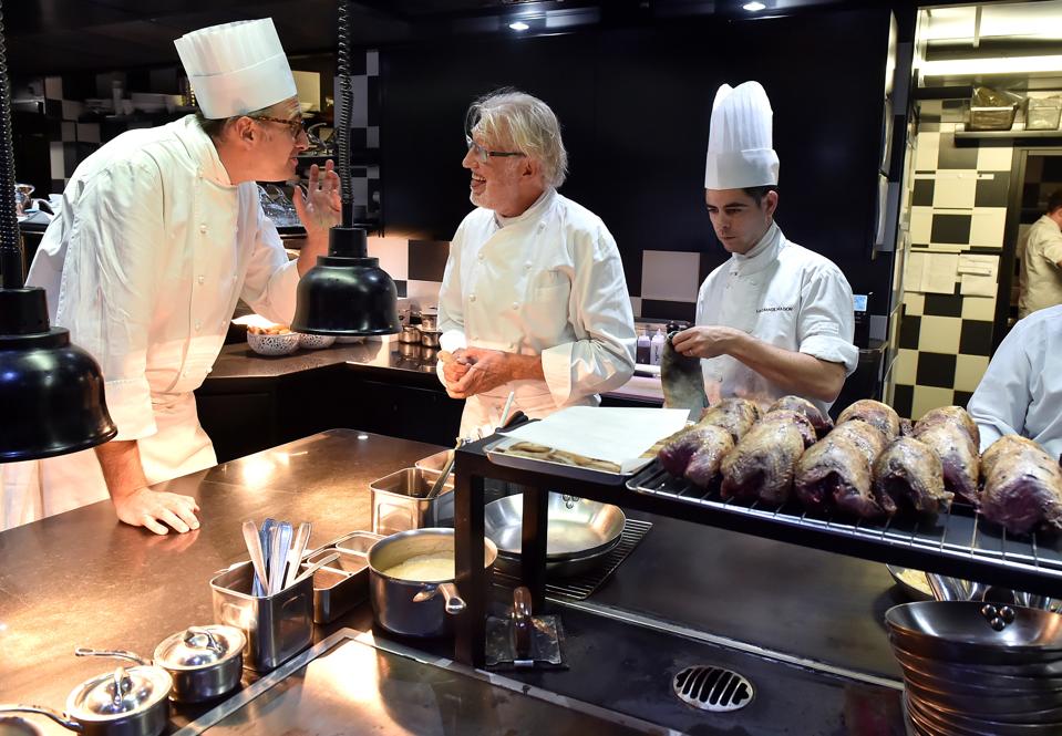 Newly appointed head chef of ″La Grande Maison″ restaurant Pierre Gagnaire (C) speaks with his executive chef Jean-Denis Le Bras in the kitchens of the restaurant in Bordeaux, on September 29, 2016. / AFP / GEORGES GOBET (Photo credit should read GEORGES GOBET/AFP/Getty Images)