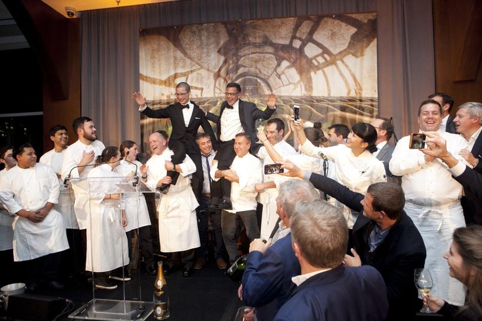 La Fête du Champagne Event with Champagne expert Peter Liem and Daniel Johnnes being lifted up