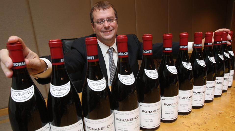 John Kapon, CEO of Acker Merrall & Condit Companies poses for photography with a full case of the legendary 1990 Romanee-Conti (estimate : HK$1,200,000-1,600,000/US$ 150,000-200,000), during a media briefing of Acker Merrall & Condit September HK Wine Auc