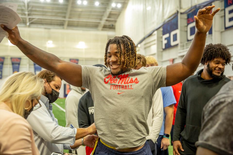Ole Miss student athlete DL Isaiah Iton getting fitted for custom Blue Delta Jeans