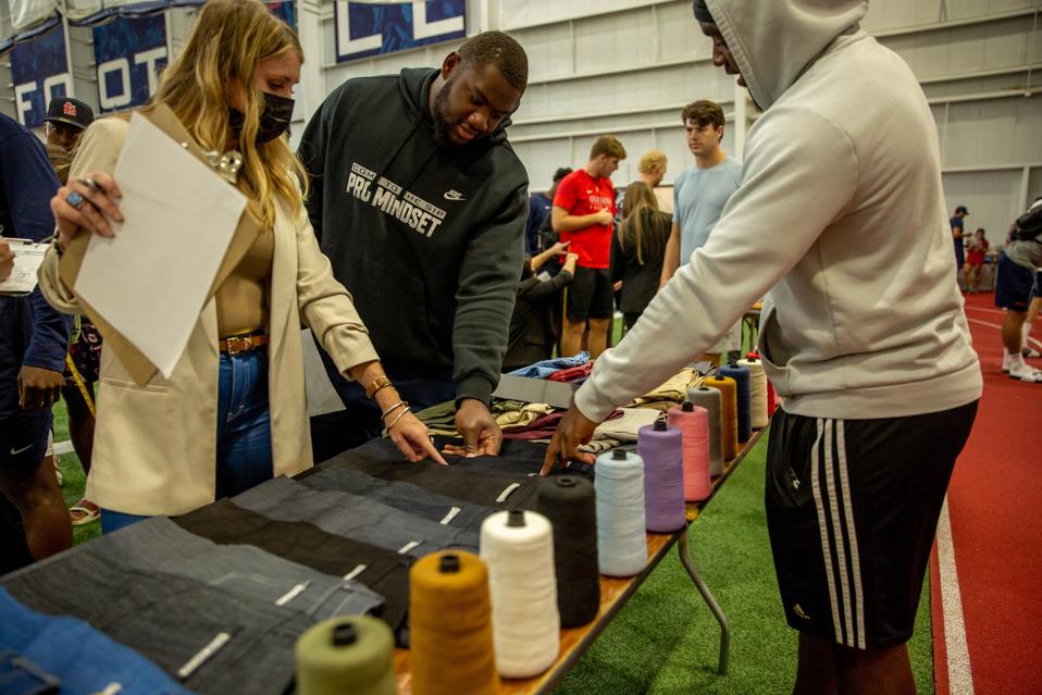 Ole Miss football student athletes choosing their fabrics and thread colors for custom jeans from Blue Delta Jeans