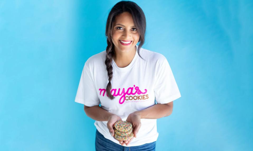 Mayas Cookies founder Maya Madsen holding 3 cookies