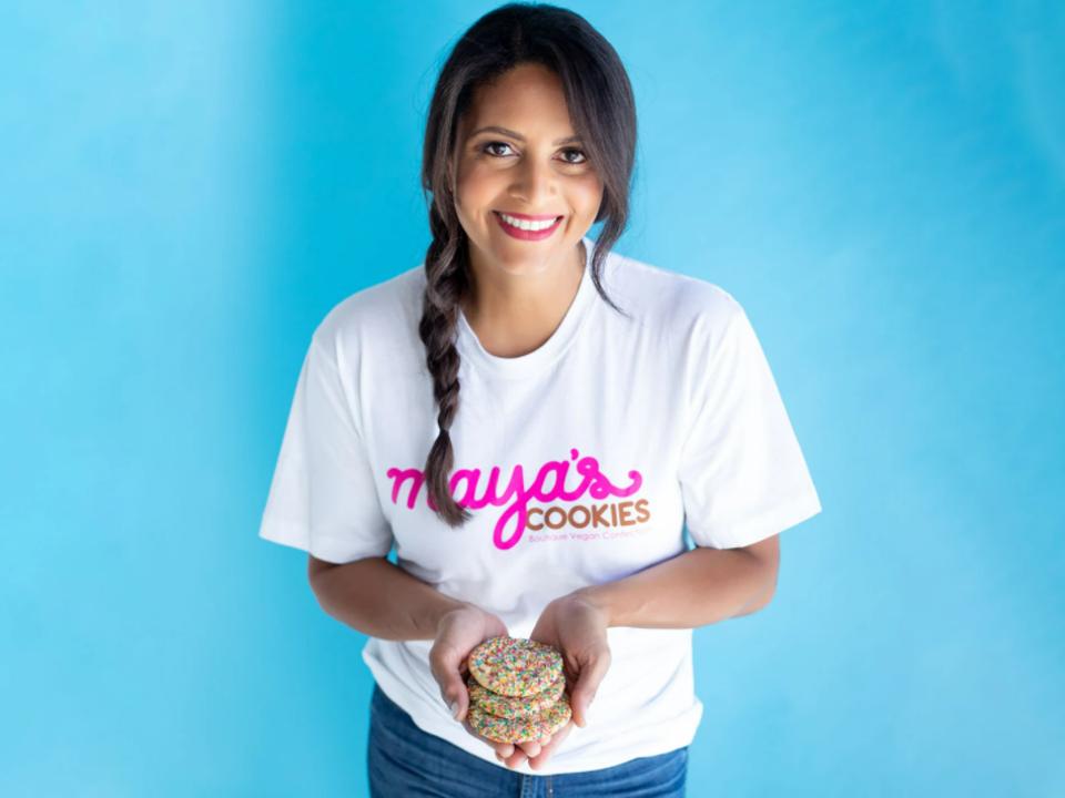 Mayas Cookies founder Maya Madsen holding 3 cookies