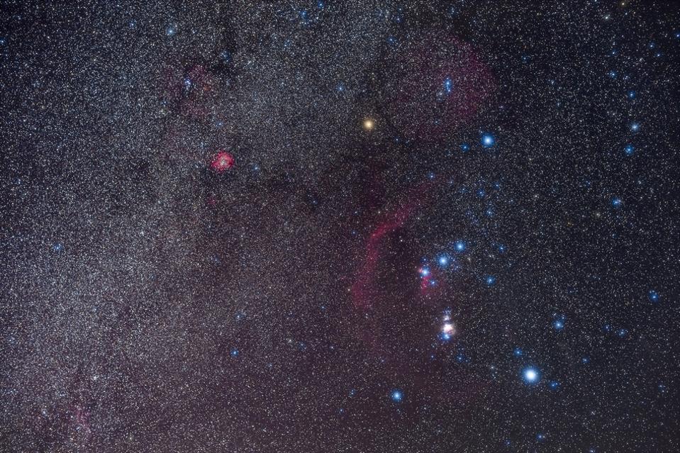 A portrait of Orion and the northern winter Milky Way, on a February night, 2020. The Orion Nebula is the bright, overexposed pink glow below the Belt of Orion, while the curving arc of red is Barnard’s Loop, now thought to be a supernova remnant. The br