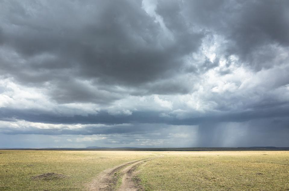 Storm on the horizon. Winding roads and dark clouds ahead.