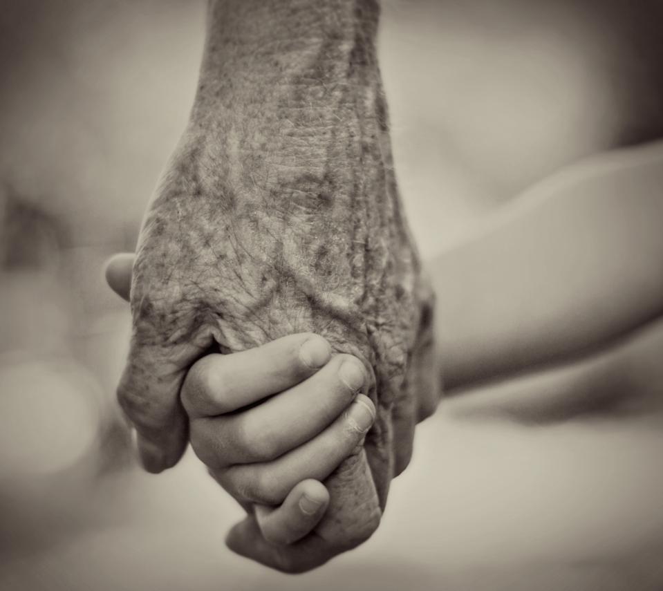 Old and young holding hands