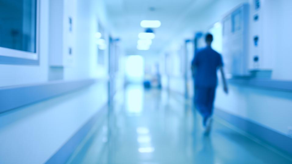 Hospital corridor and doctor as a blurred defocused background