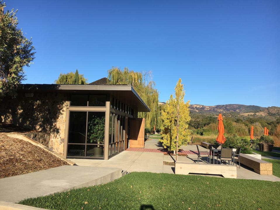 Saracina's single-story modern tasting room has a large patio with tables and umbrellas