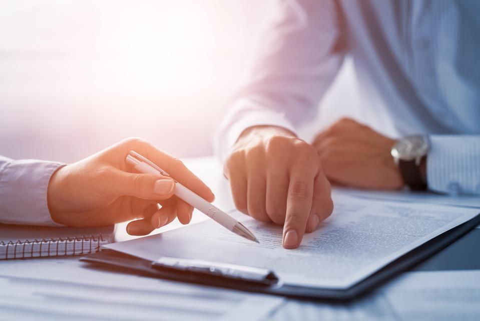 Business people negotiating a service-level agreement.