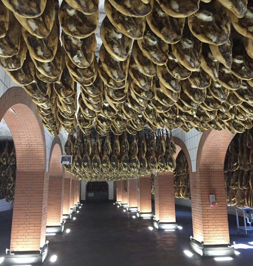Pig haunches hanging in the Cinco Jotas cellars in Jabugo, Spain