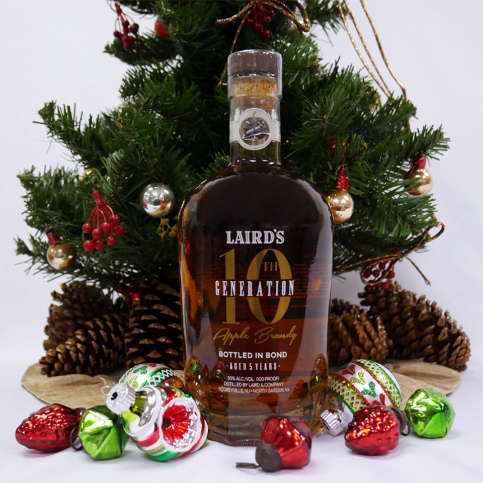 bottle of apple brandy, ornaments, tree and pine cones