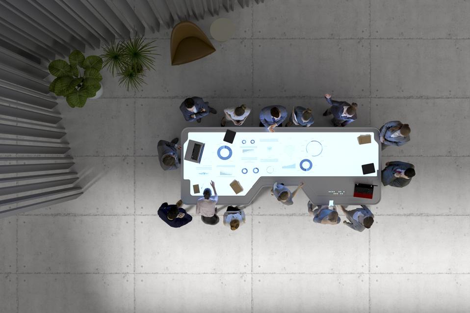 Group of business people with futuristic working desk showing importance of engagement.