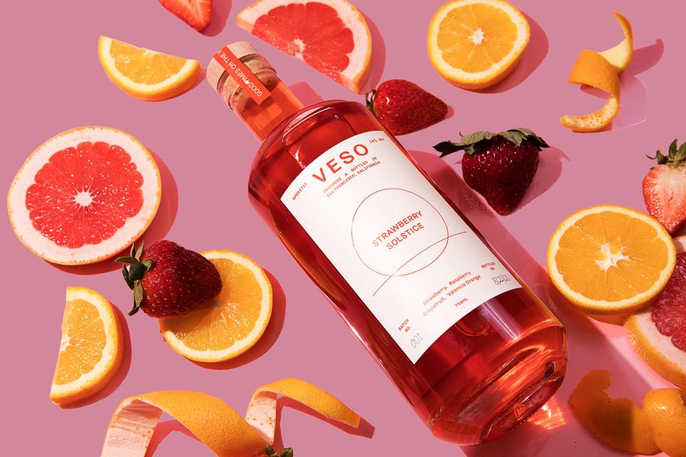 bottle of aperitivo with fruit floating around it