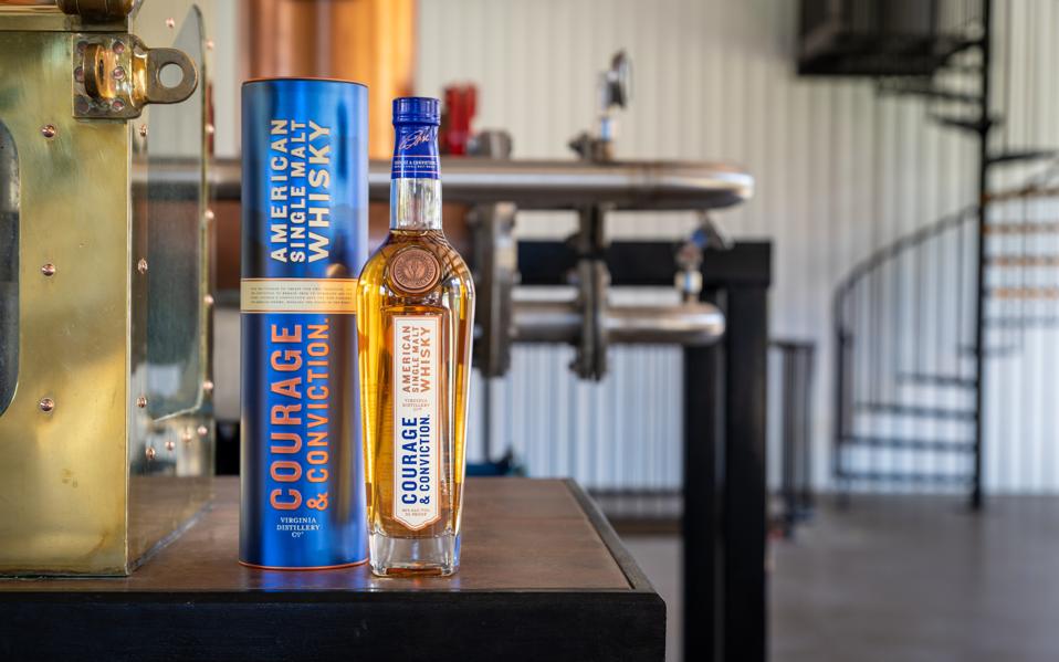 Courage & Conviction flagship bottle with spiral staircase in background
