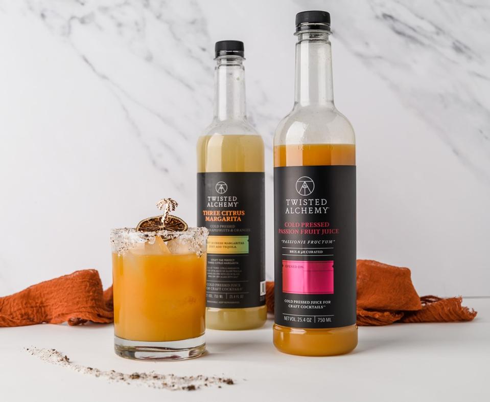 Passion fruit margarita with Twisted Alchemy juice bottles