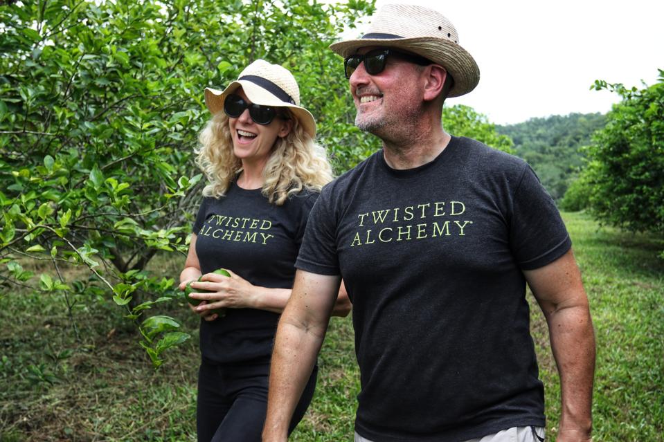 Kim and Scott Holstein walking in a citrus grove