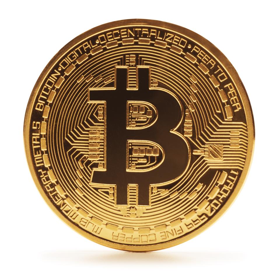 A physical unit of digital currency bitcoin against a white background