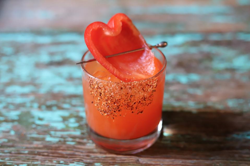 Red Pepper Margarita in a cocktail glass with pepper garnish