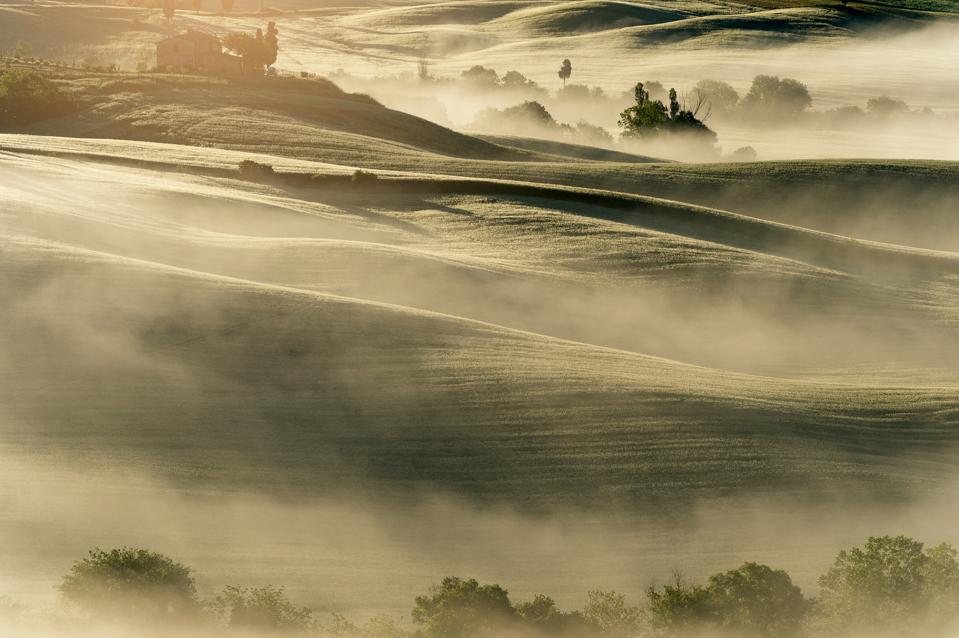 amazing tuscany landscape the mist cover rice field in early morning Toscana italy