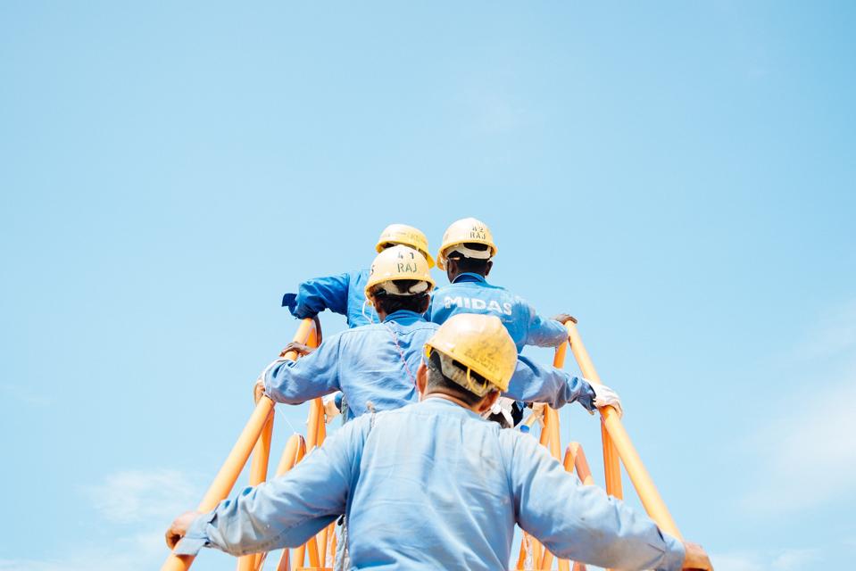 workers in a Singaporean shipyard disembark a gas vessel during a planned fire drill.