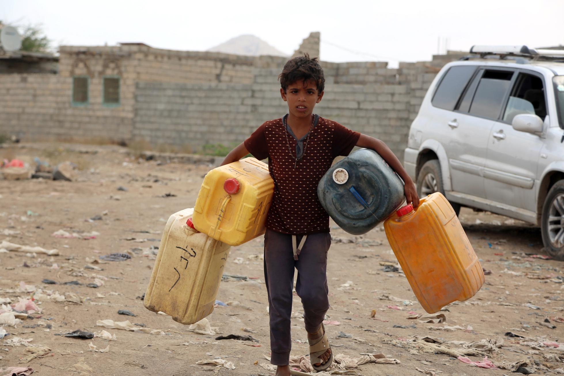 A Yemeni child carries empty jerrycans amid continuing wide spread disruption of water supply in the impoverished coastal village on the outskirts of the Yemeni port city of Hodeidah. 