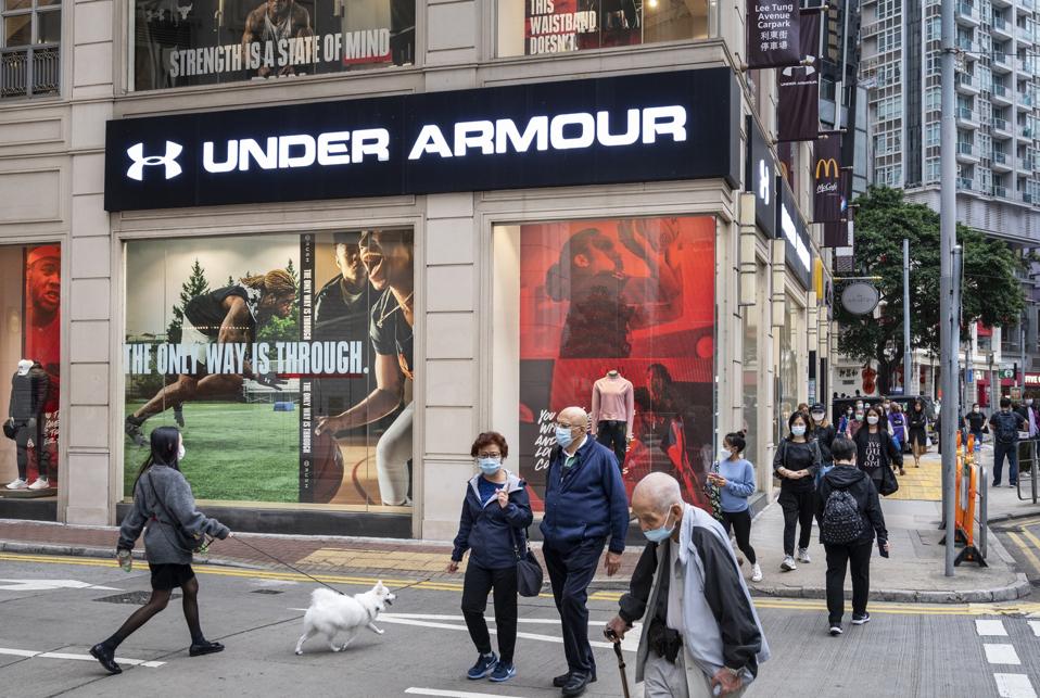 Pedestrians walk past the American multinational clothing...