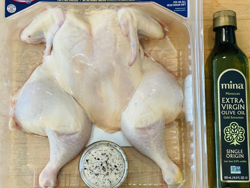 All you need to make a great grilled butterflied chicken is  the grill, a chicken, olive oil and salt and pepper. Shown in this photograph by Elizabeth Karmel is the spatchcock chicken, olive oil and salt and pepper.