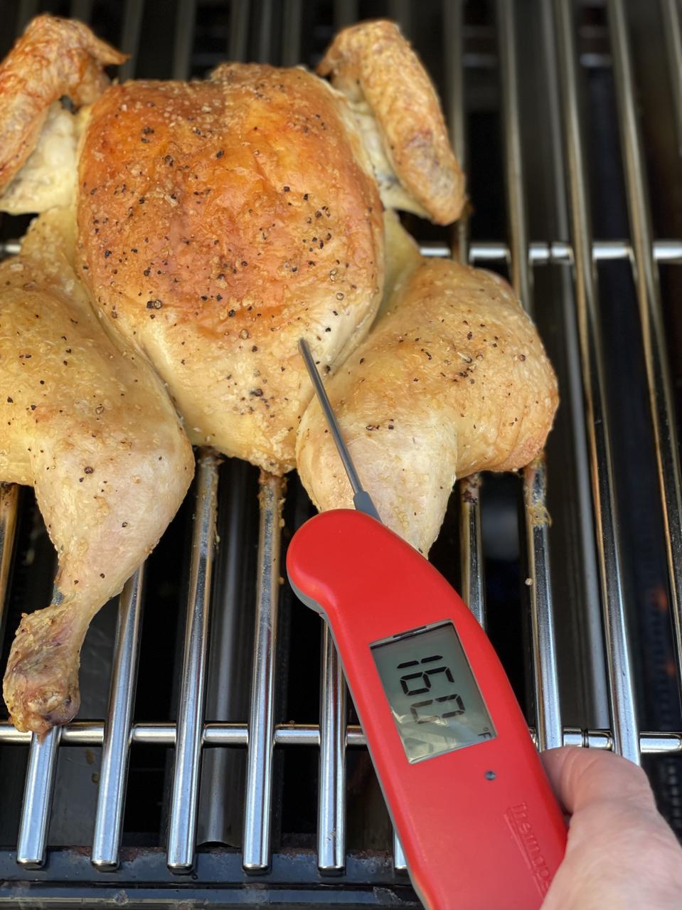 A butterflied or spatchcock chicken cooks at the same rate so the breast meat and the thigh meat are done at the same time. In this photo by Elizabeth Karmel, the breast meat registers 160F on an instant-read thermometer.