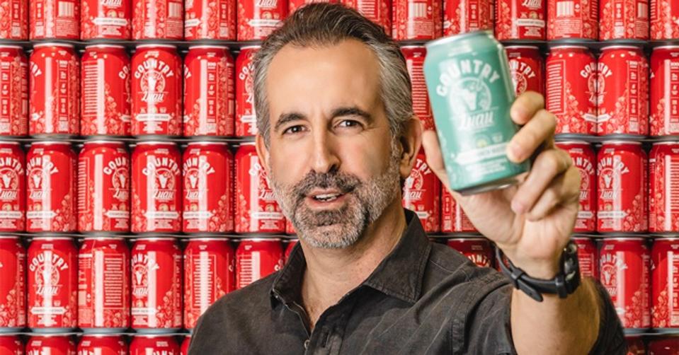 adam kost headshot with canned drinks