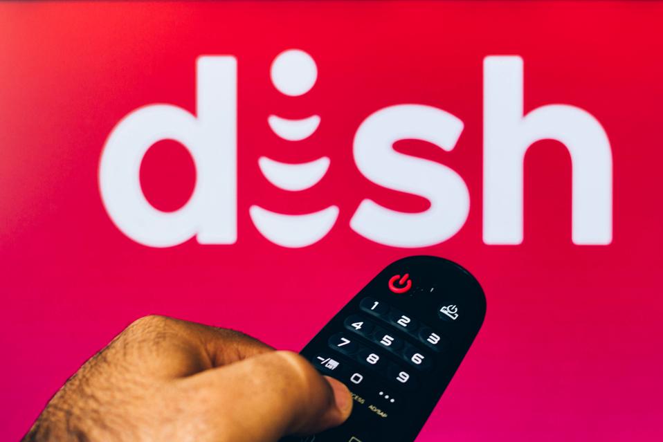 In this photo illustration, a hand holding a TV remote...