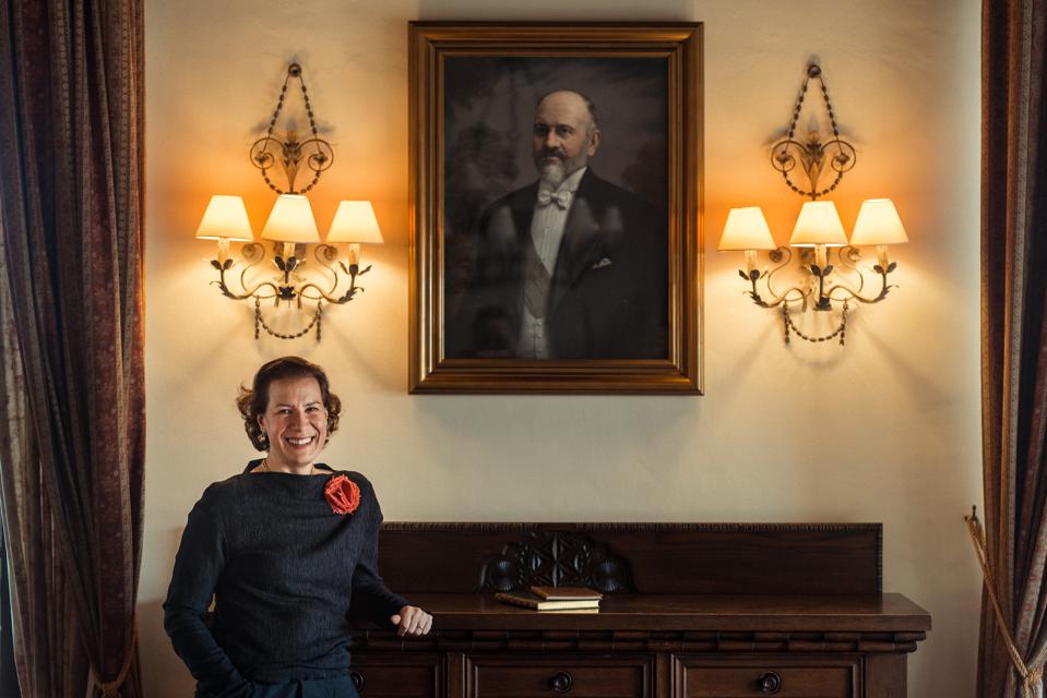 Elena de Cardini Raventós in front of a portrait of a family member in Castillo de Raymat.