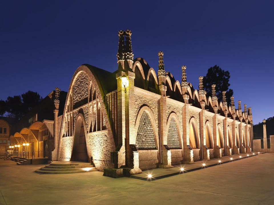 The stone Raimat winery in Lleida, Spain, in DO Costers del Segre is lit up at night.