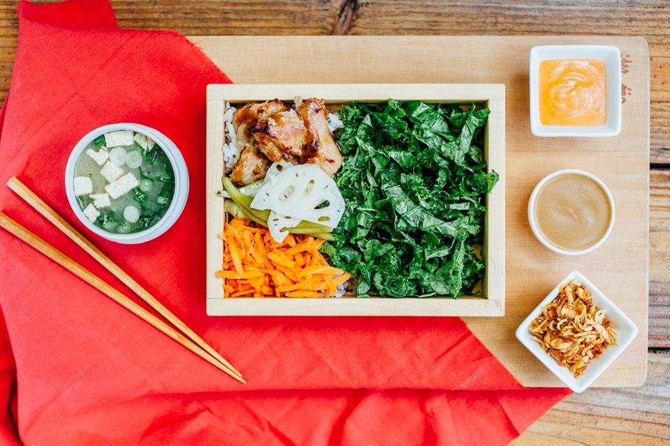 A colorful bento box on a wooden table