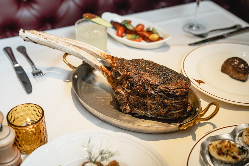 Dean’s 50 ounce Tomahawk Ribeye, served bone-in at the table.