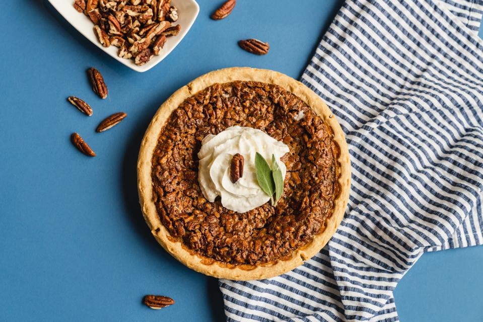 Blue Lacy’s Texas Pecan Pie on a blue table with white and blue napkin
