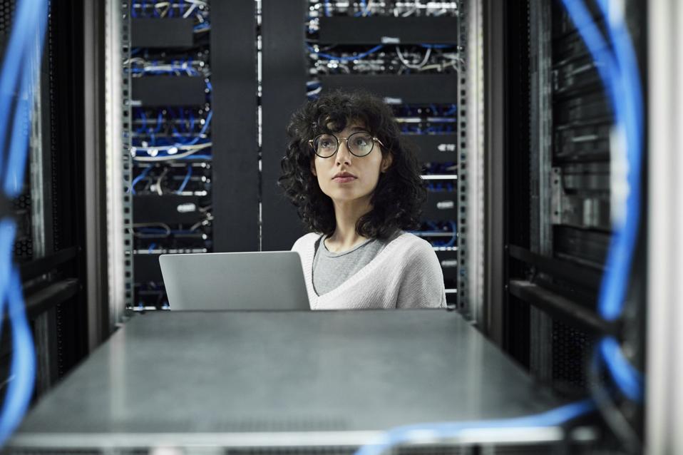 Female technician standing in server room
