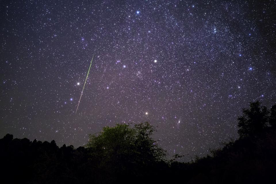 Meteor shower and starry night sky.