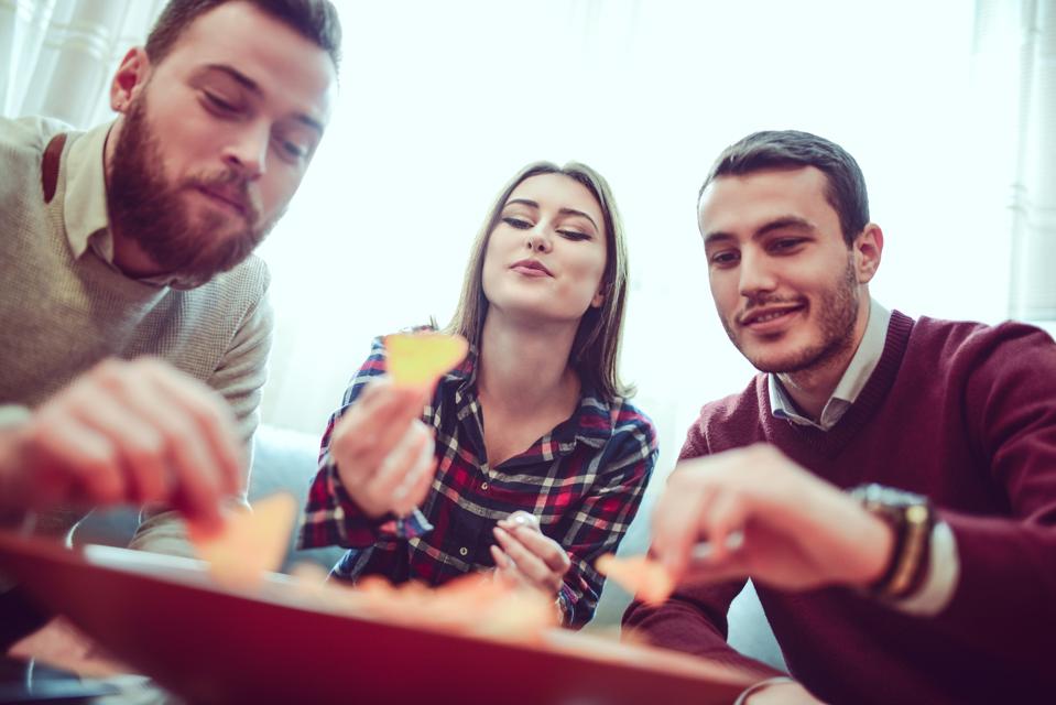Group of Friend Eating Snacks, Conversing and Having Fun Time Together