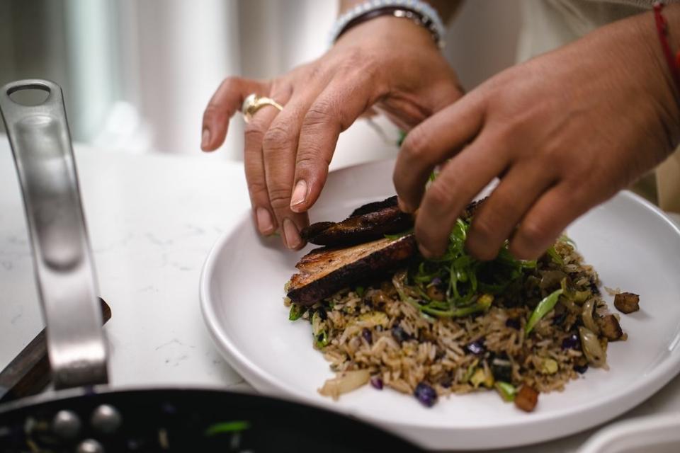 Chef LaMara plating a CookUnity dish.