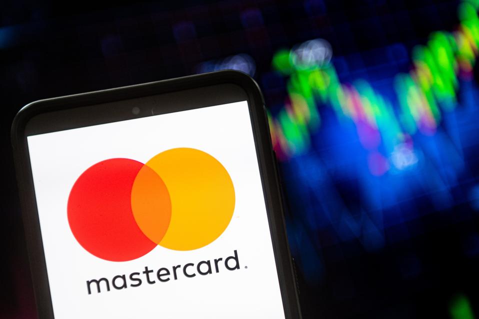 In this photo illustration a Mastercard logo seen displayed...