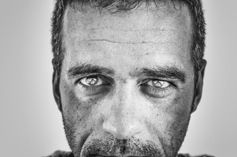 Close-Up Portrait Of Man Against White Background