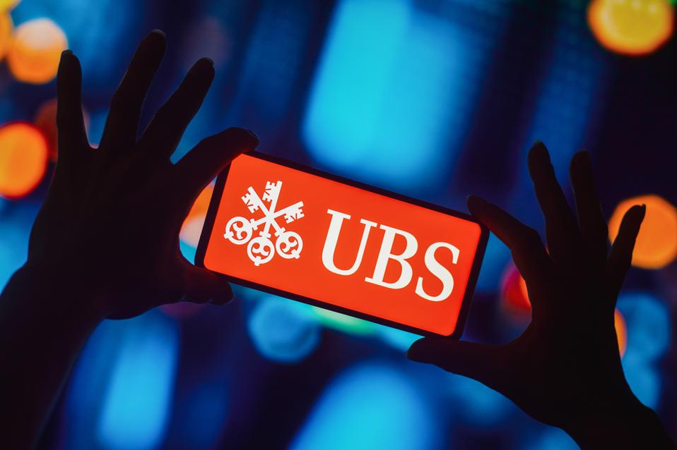 In this photo illustration, the UBS Group AG logo is...