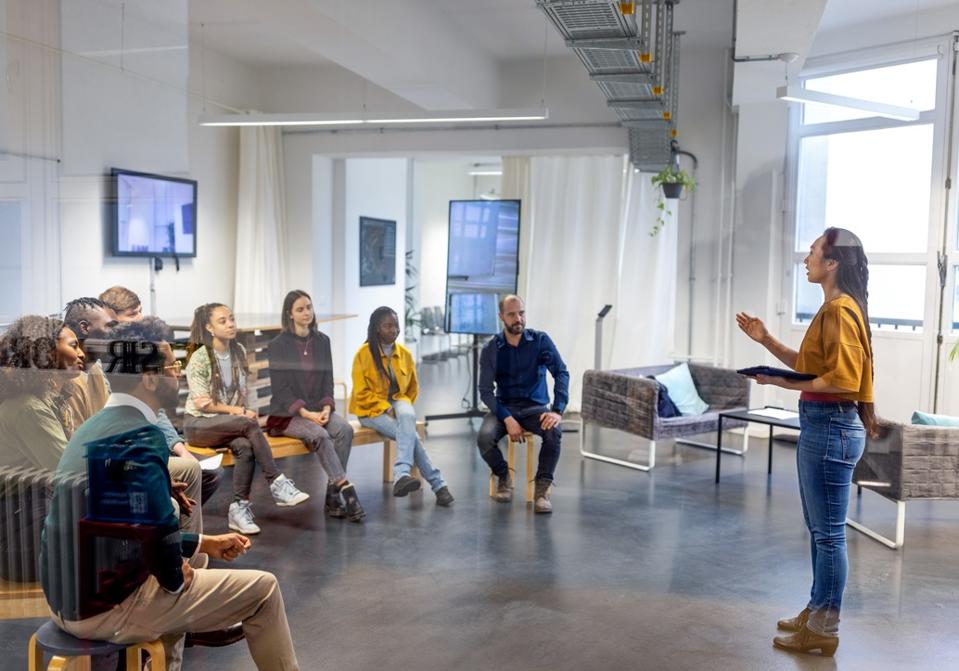 Young asian businesswoman speaking to her coworkers in meeting