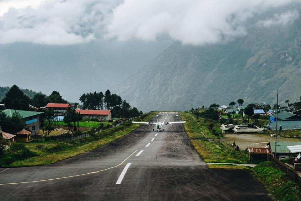 Airplane taking off from the runway of Tenzing–Hillary in Lukla, Nepal.