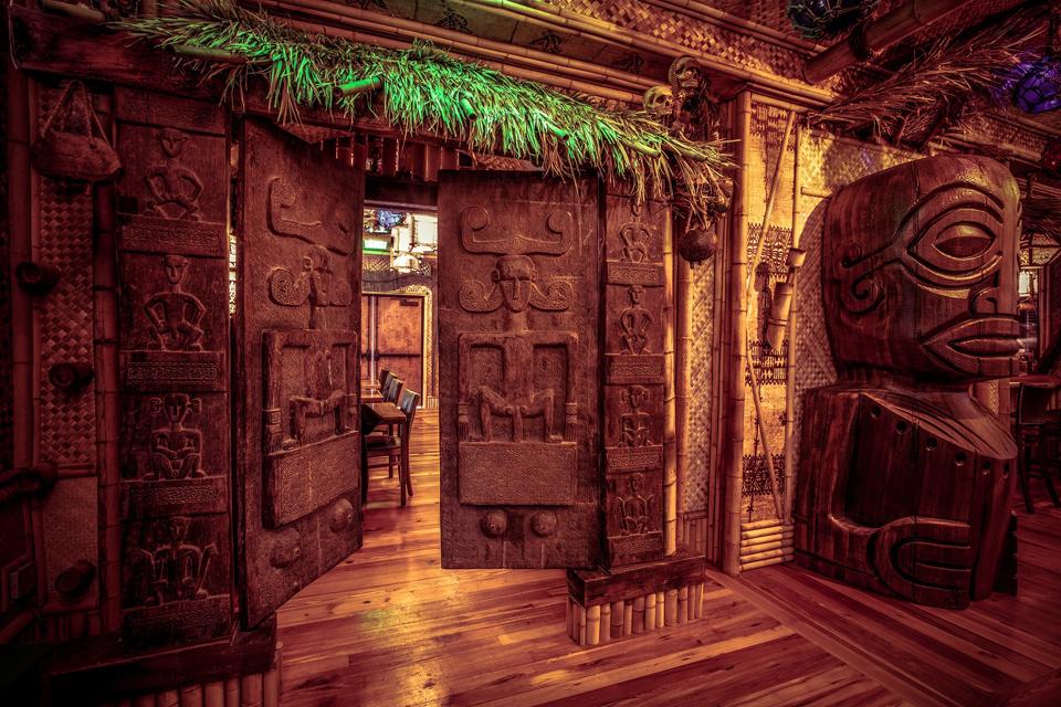 The over 500-year-old fertility doors inside The Bamboo Room are featured on much of the bars glassware.