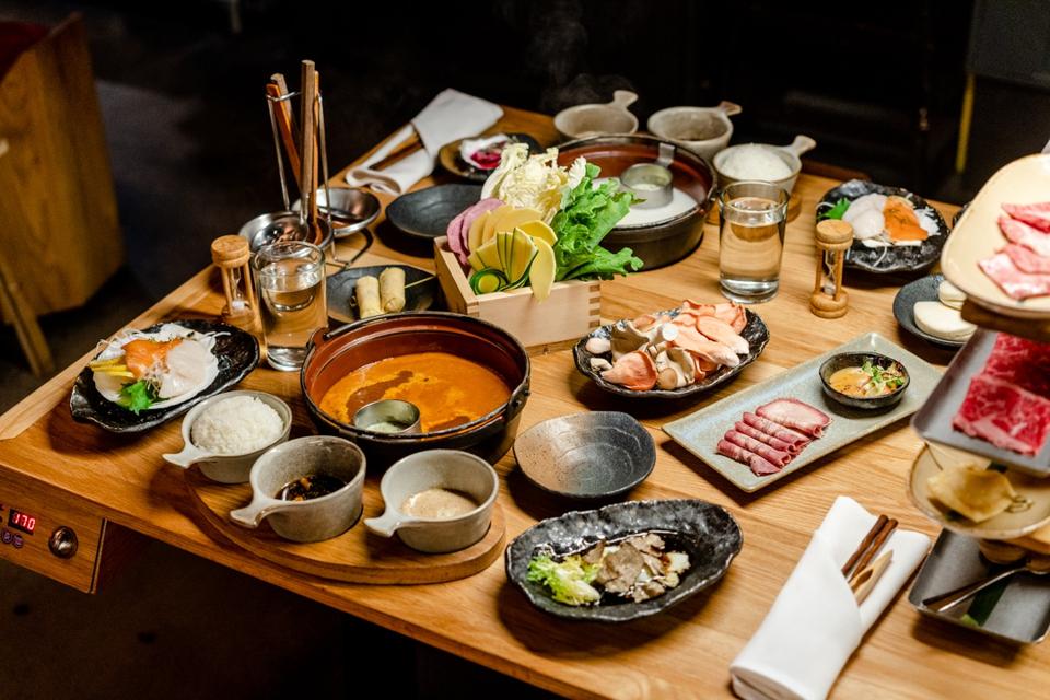A table set with the traditional Japanese shabu-shabu dinner.
