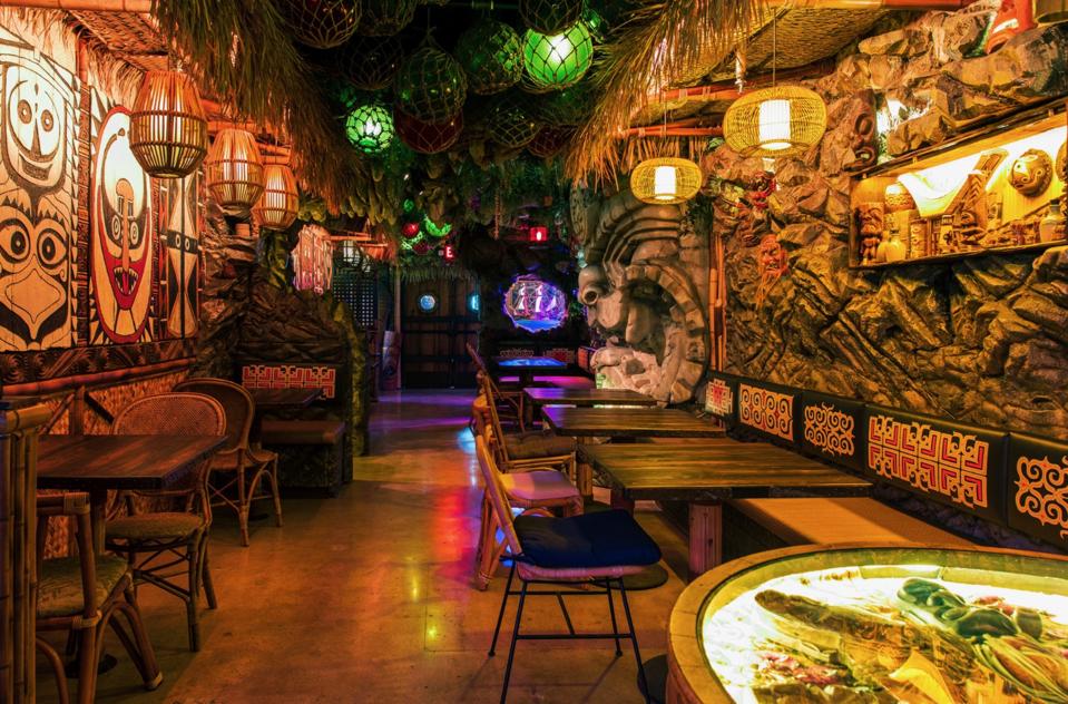 A low-lit dining room brimming with Tiki decor